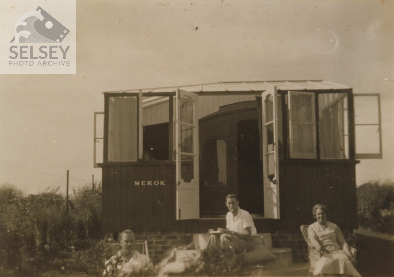 People outside Railway carriage home, Merok - featured image