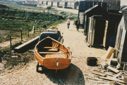 Fishshops by beach with boat - thumbnail image