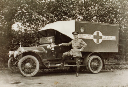 Serviceman poses on Red Cross van - thumbnail image