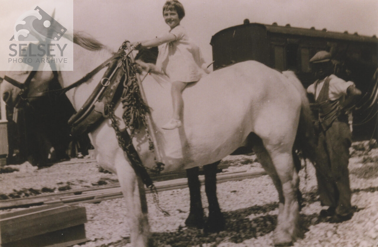 A child on horse pulling railway carriage - featured image