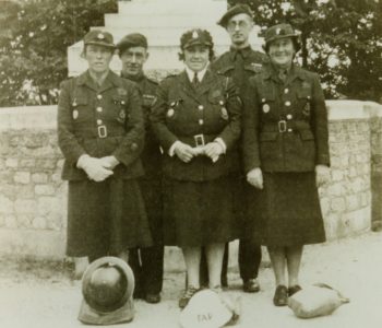 Three women and two men in Civil Defence uniform in front of Selsey War Memorial - thumbnail image