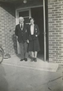 Selsey: Man and lady at entrance to East Street School Hall - thumbnail image
