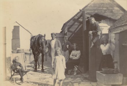 Selsey: A family group in front of stables - thumbnail image